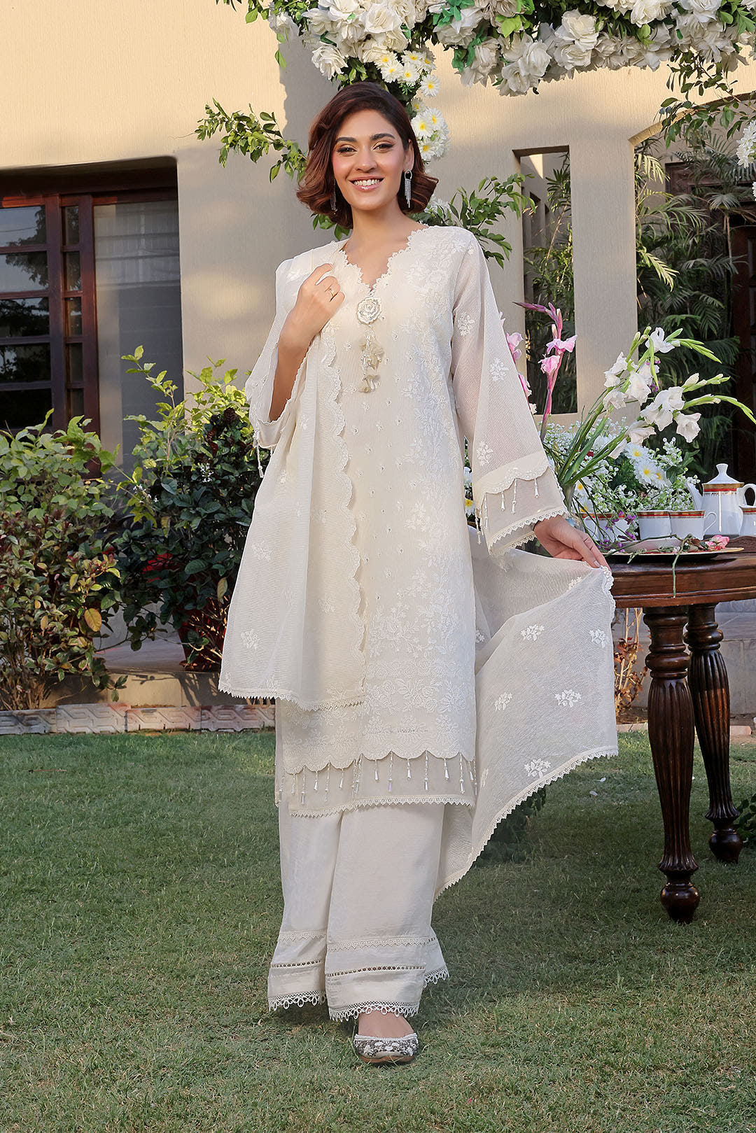 women white unstitched embroidered khaddi net suit Pakistan
